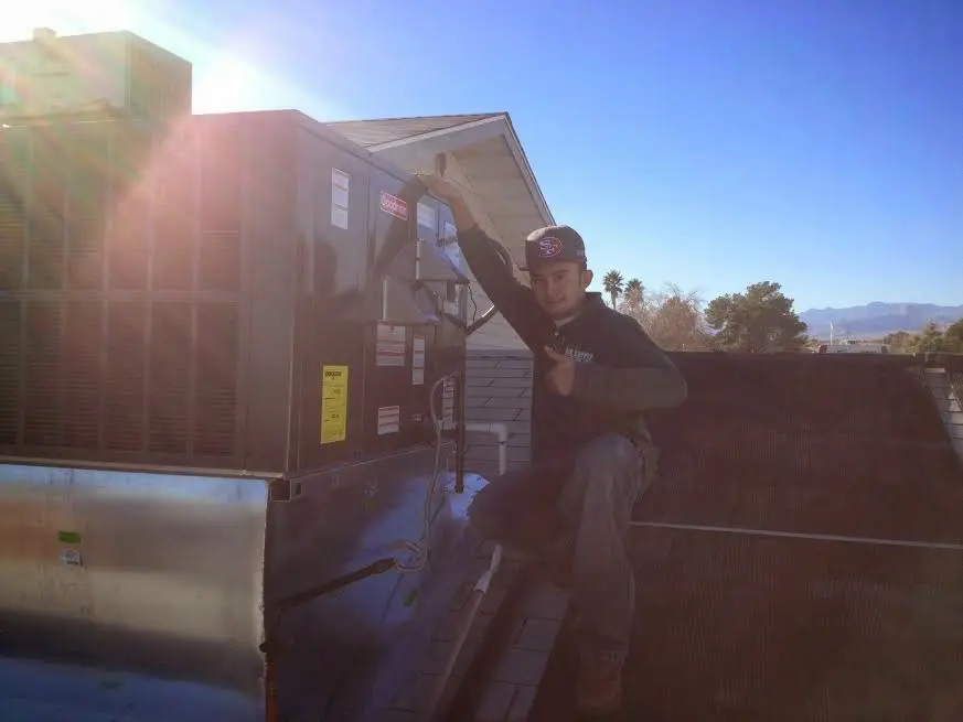 HVAC technician performing HVAC Inspection on a rooftop unit in Chillicothe